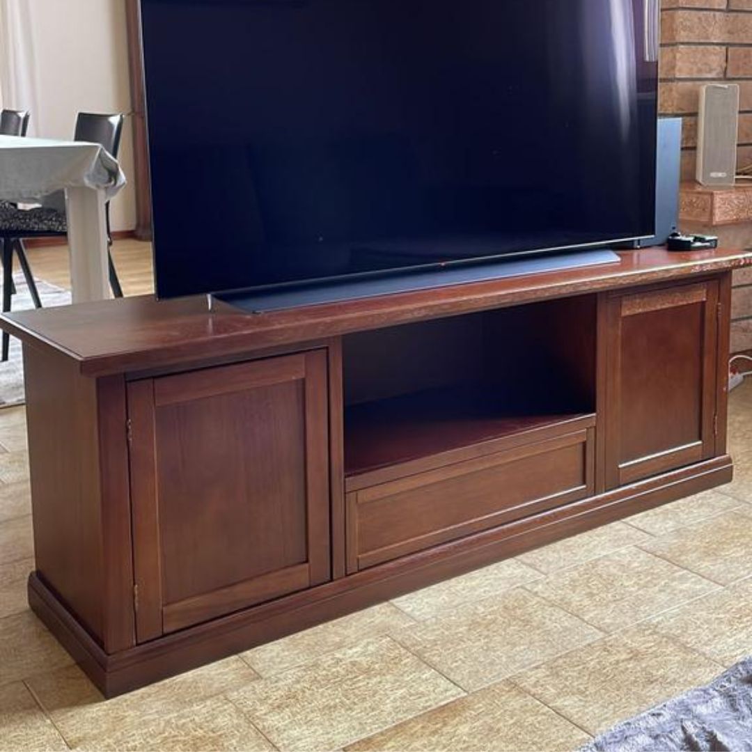 Dettaglio mobile porta TV in legno noce scuro stile classico con vano a giorno.